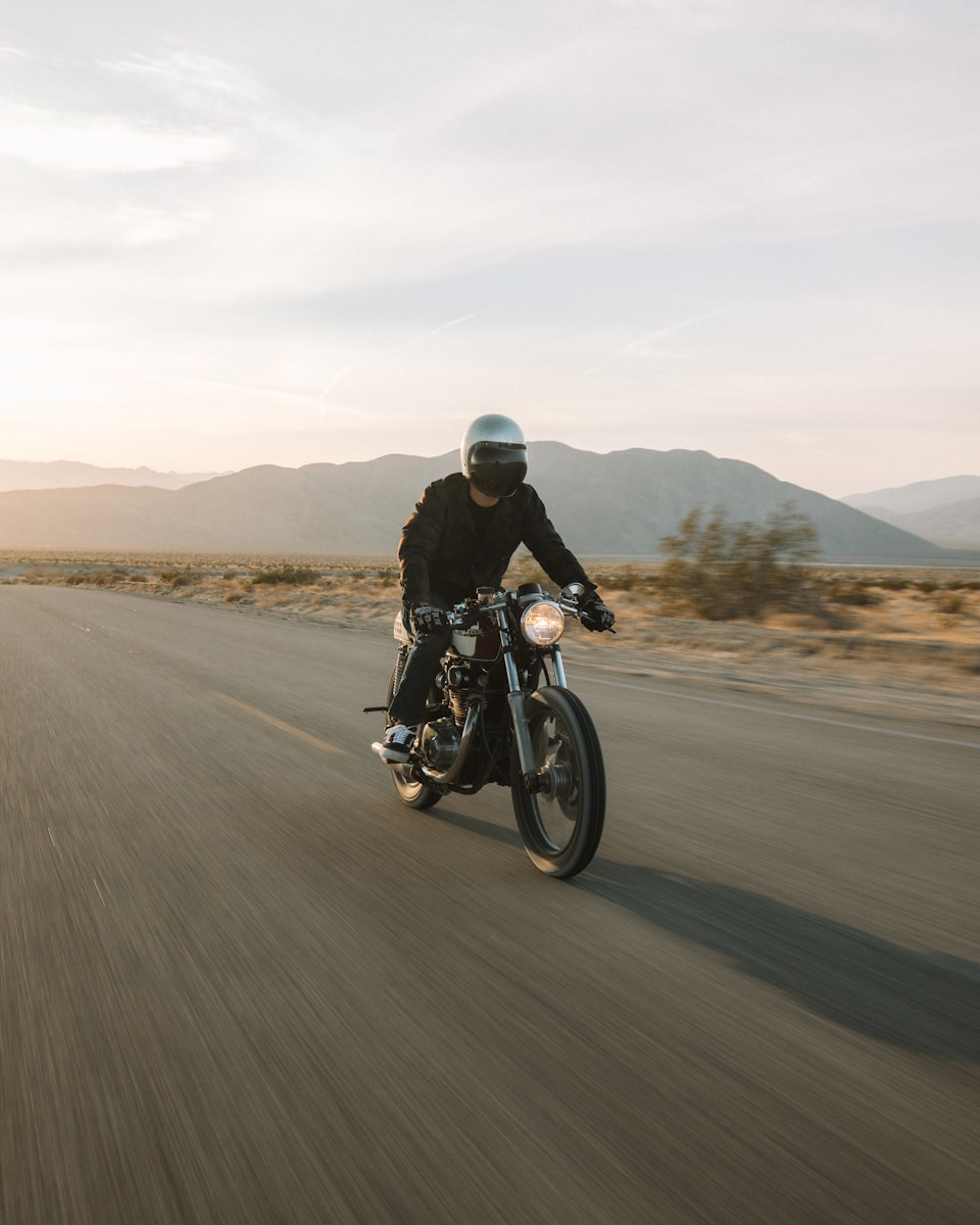 man riding motorcycle on road during daytime